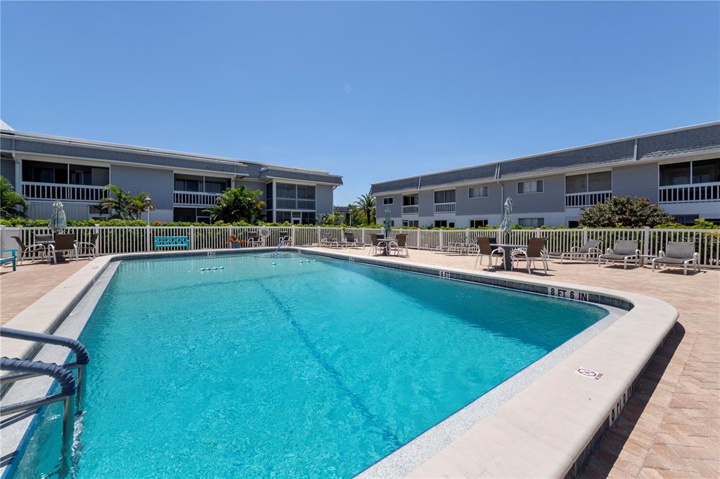 22375 Edgewater Drive, Unit 238 Punta Gorda, FL 33980 - Photo 3 of 57 a swimming pool with outdoor seating and yard