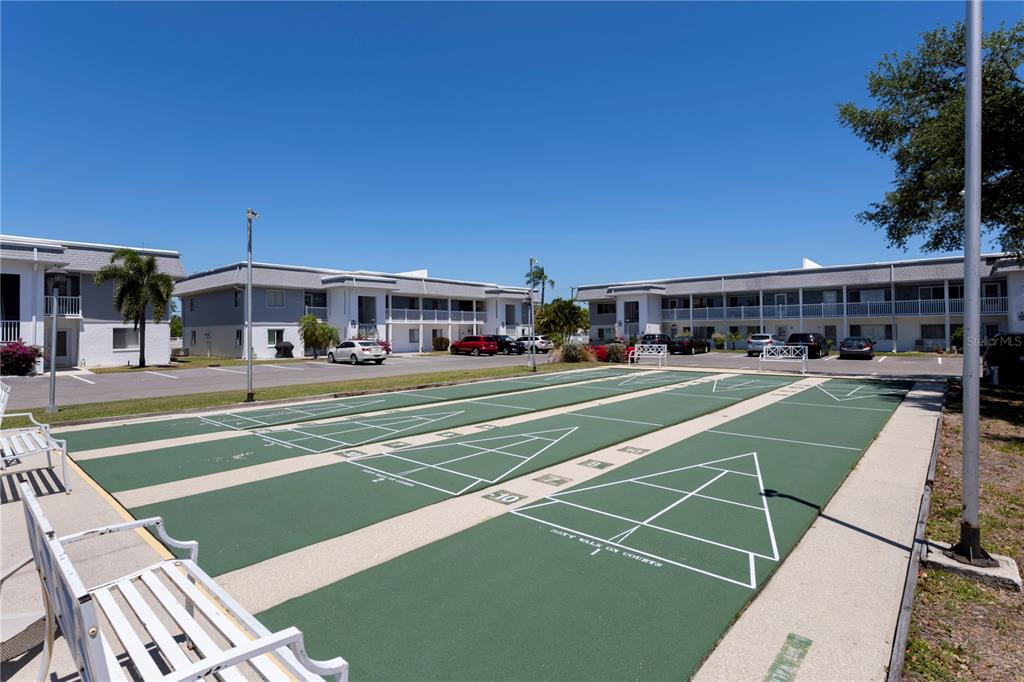 22375 Edgewater Drive, Unit 238 Punta Gorda, FL 33980 - Photo 41 of 57 a view of a tennis ground with large trees