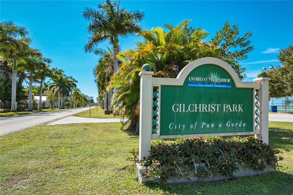 22375 Edgewater Drive, Unit 238 Punta Gorda, FL 33980 - Photo 53 of 57 a sign that is sitting on a brick wall with a big yard