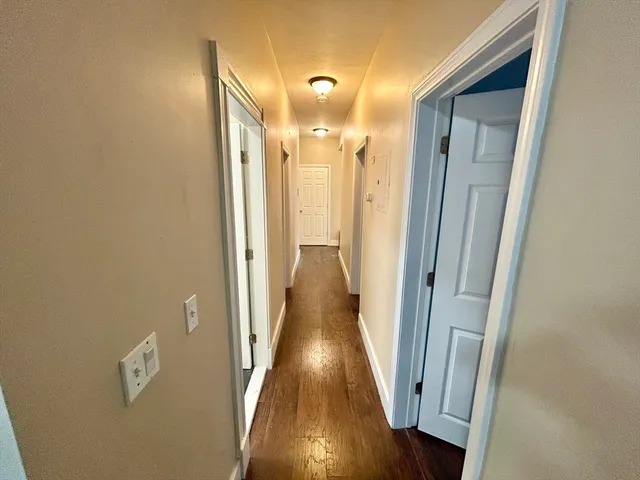 a view of gallery with wooden floor