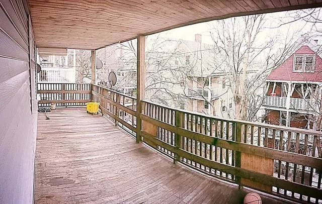 a view of a balcony with wooden floor
