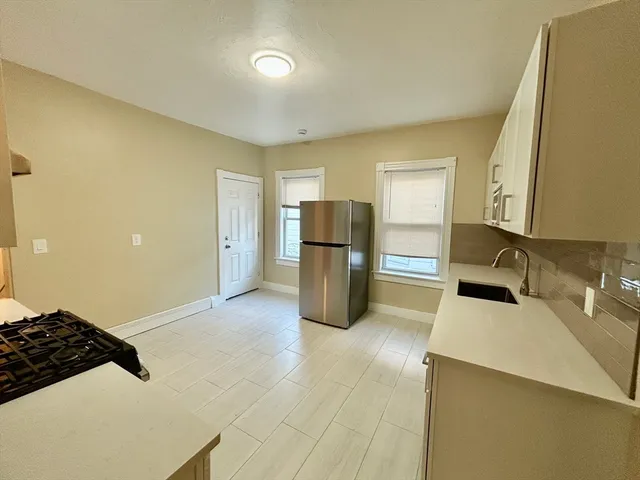 a kitchen with a refrigerator and a sink