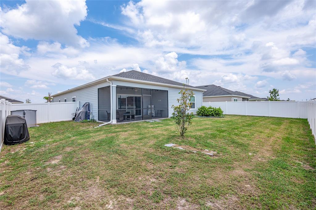 5688 Southwest 92nd Place Ocala, FL 34476 - Photo 51 of 54 a view of a house with a yard and garage