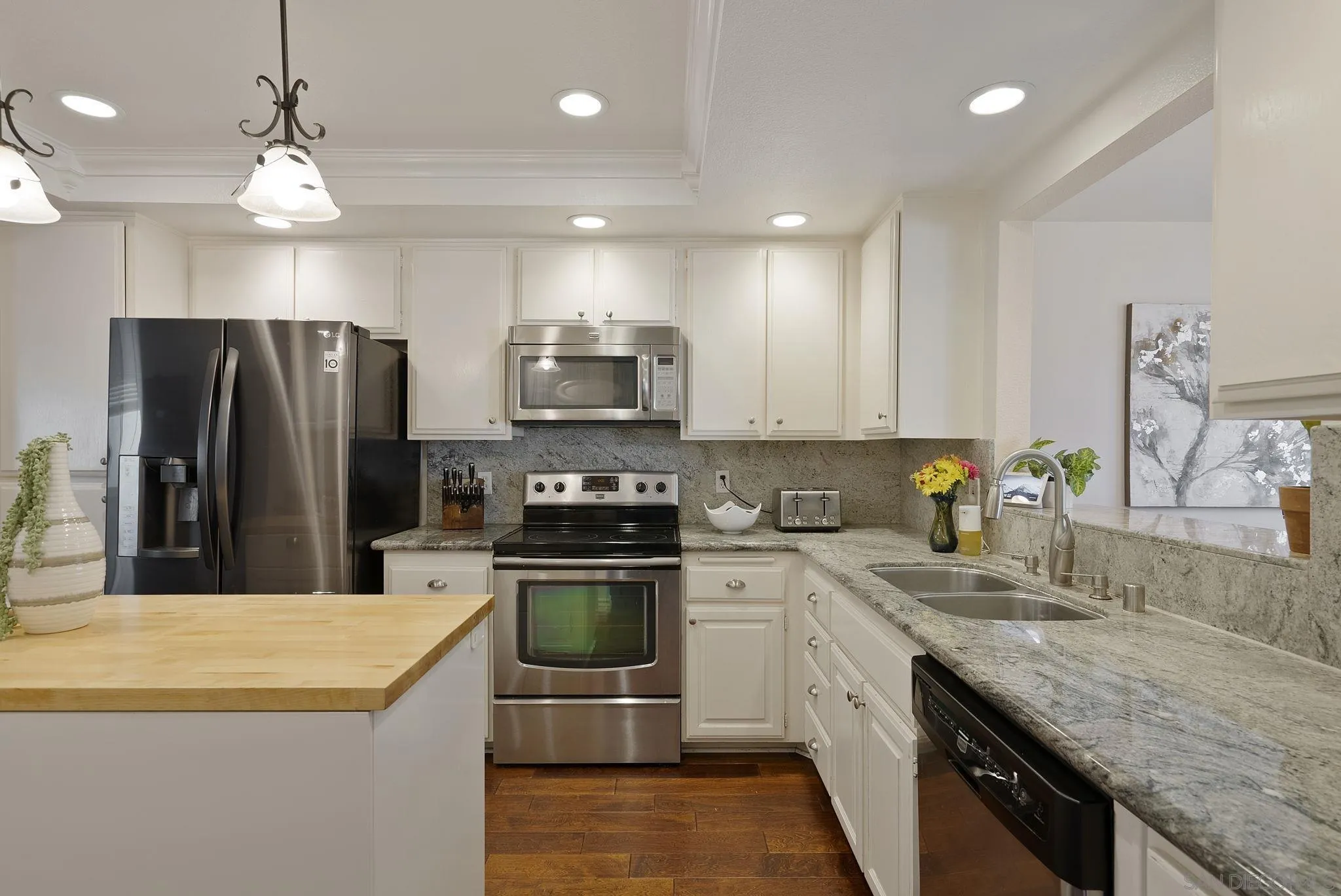 6561 Corte Cisco Carlsbad, CA 92009 - Photo 11 of 36 a kitchen with kitchen island granite countertop stainless steel appliances and sink