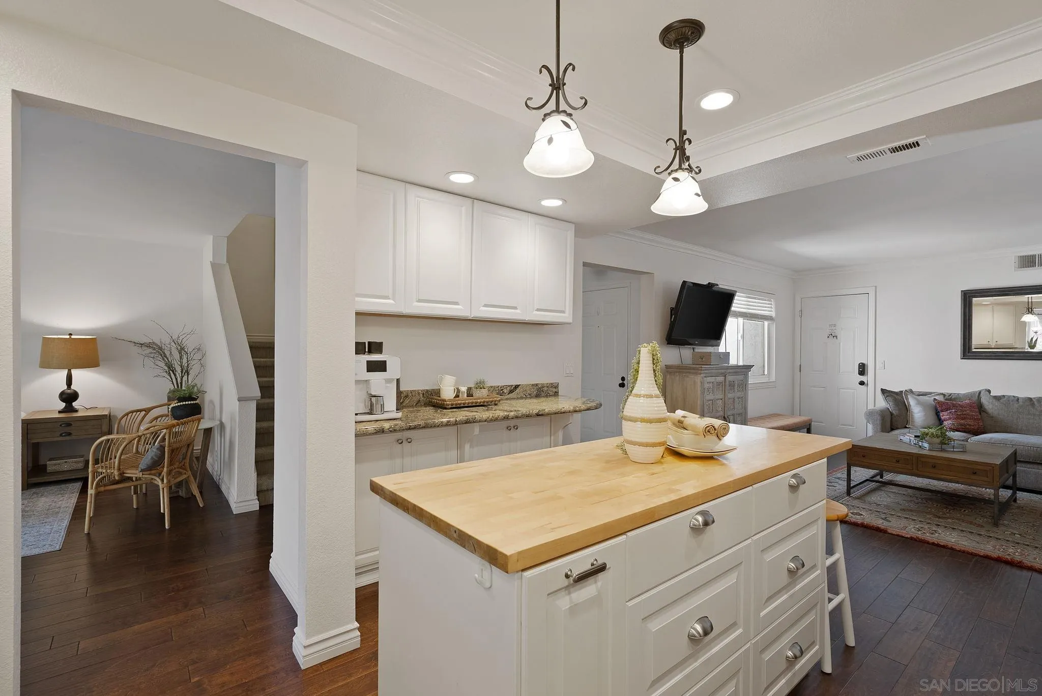 6561 Corte Cisco Carlsbad, CA 92009 - Photo 14 of 36 a kitchen that has a stove a table and chairs in it