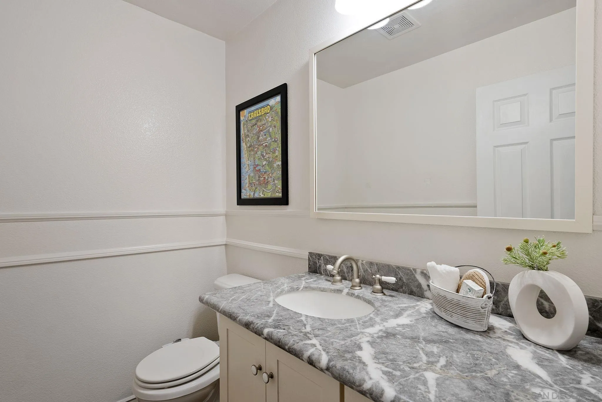 6561 Corte Cisco Carlsbad, CA 92009 - Photo 18 of 36 a bathroom with a granite countertop toilet sink and mirror