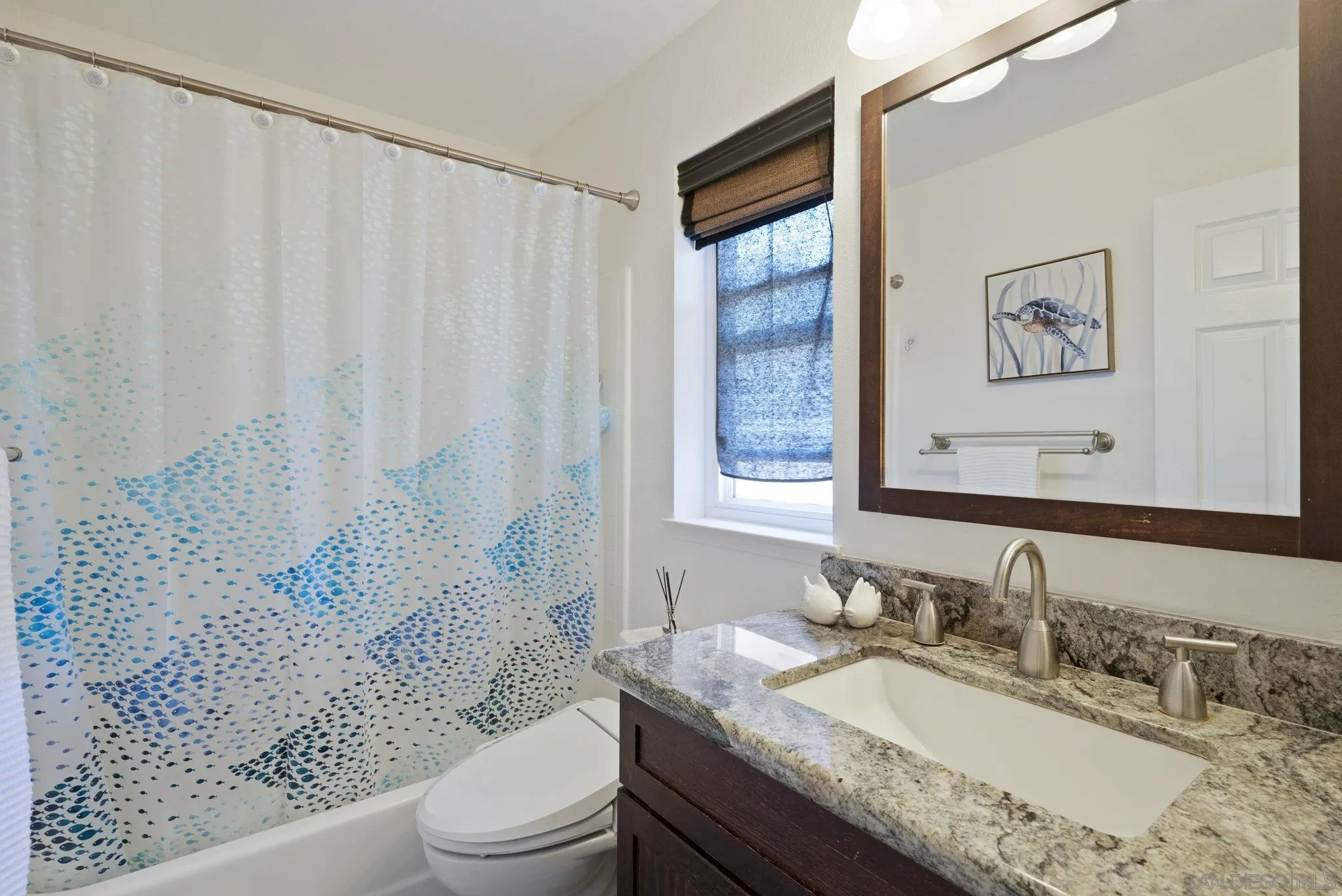 6561 Corte Cisco Carlsbad, CA 92009 - Photo 23 of 36 a bathroom with a granite countertop sink a toilet and a mirror