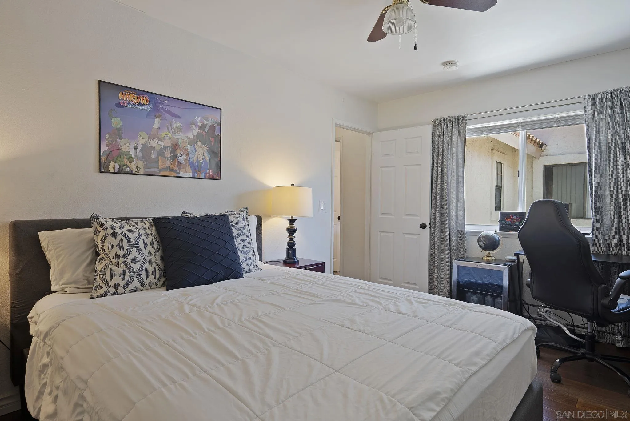 6561 Corte Cisco Carlsbad, CA 92009 - Photo 25 of 36 a bedroom with a bed and a chandelier