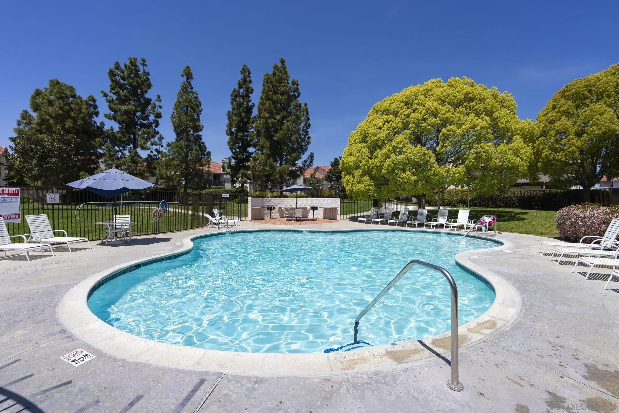 6561 Corte Cisco Carlsbad, CA 92009 - Photo 31 of 36 a view of swimming pool with outdoor seating and trees in the background
