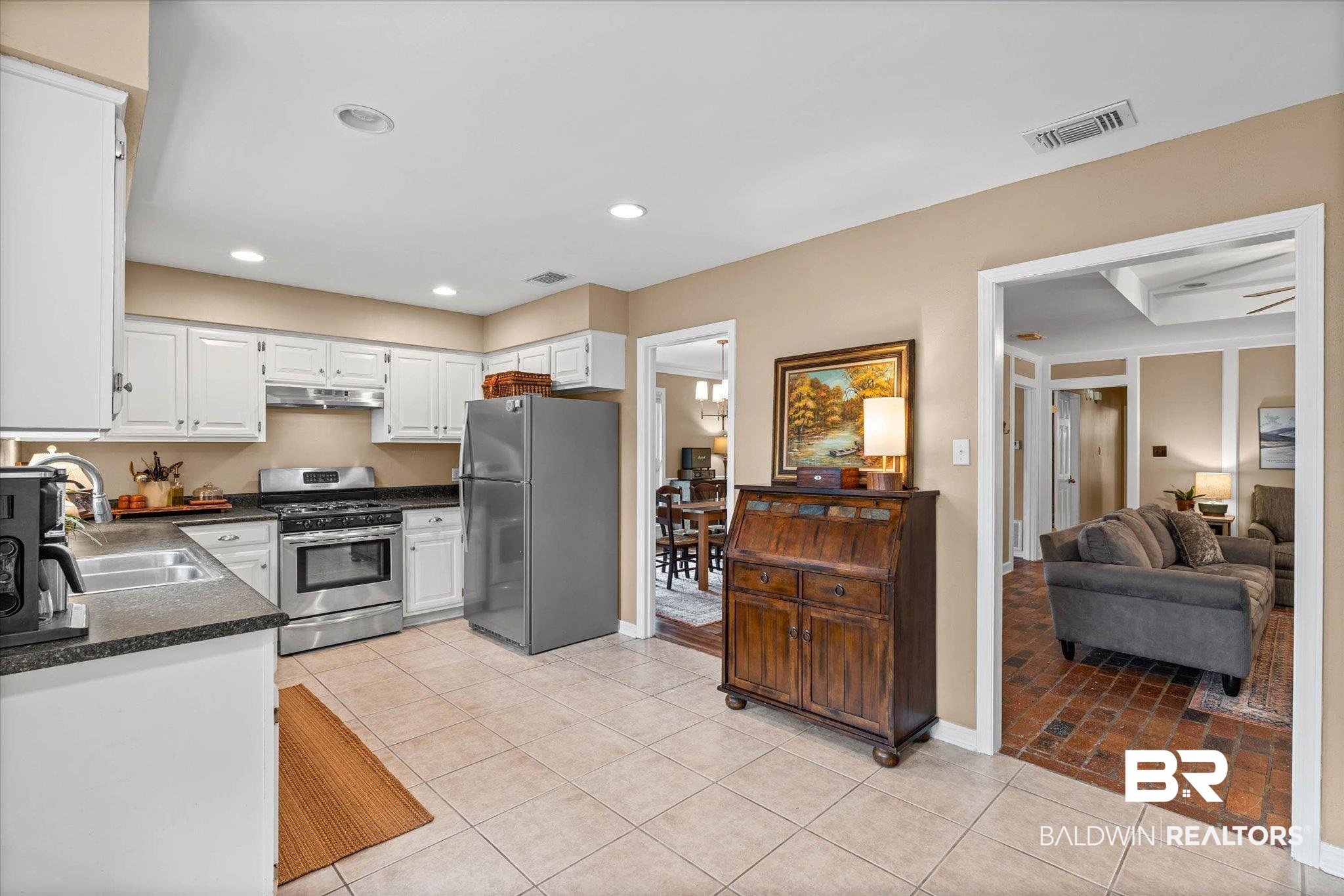 6501 Gas Light Lane South Mobile, AL 36695 - Photo 7 of 23 Kitchen featuring white cabinetry, dark stone countertops, stainless steel appliances, and tile flooring