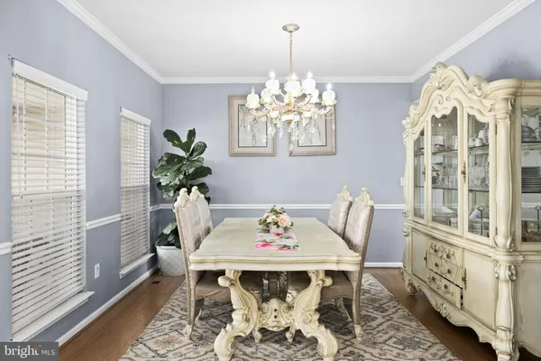 a view of a dining room with furniture and chandelier