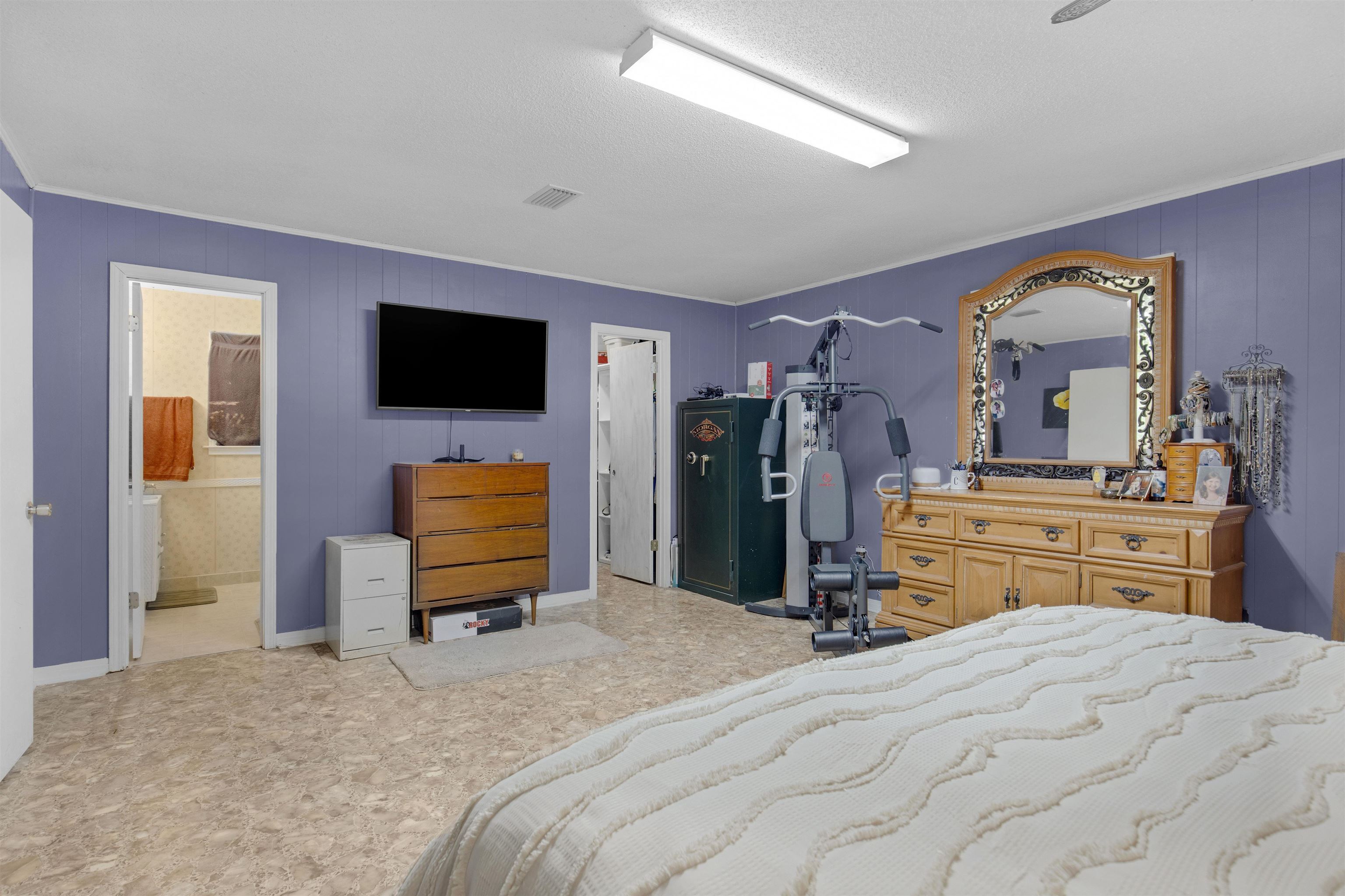 1147 Mack Pond Road Atmore, AL 36502 - Photo 12 of 40 Bedroom featuring connected bathroom and a textured ceiling