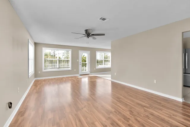 a kitchen with stainless steel appliances a stove a sink and white cabinets