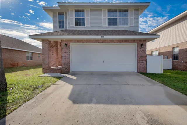 a view of a house with a yard and garage