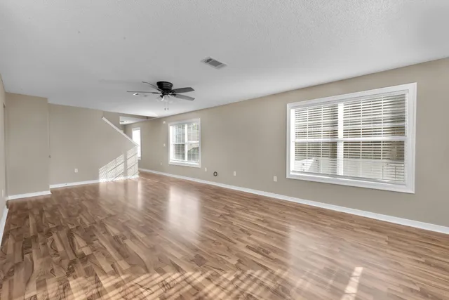 a view of a livingroom with a dishwasher and wooden floor