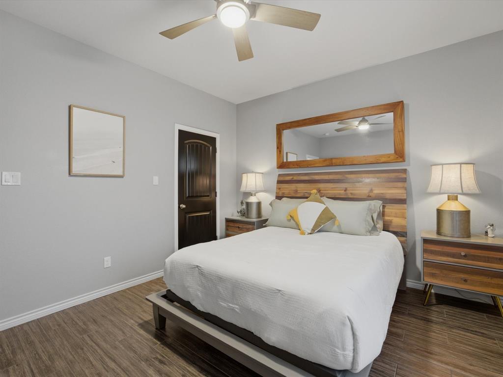 117 Ranchview Court Bowie, TX 76230 - Photo 19 of 40 a bedroom with a bed and a chandelier