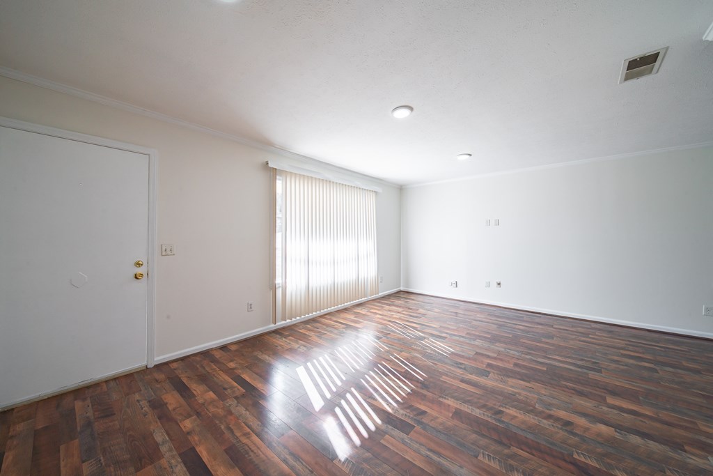 1829 Celeste Drive Columbus, GA 31907 - Photo 15 of 33 a view of an empty room with wooden floor and window