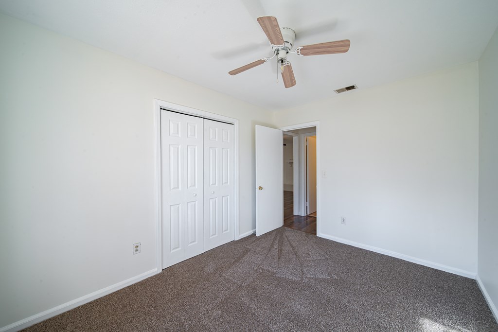 1829 Celeste Drive Columbus, GA 31907 - Photo 21 of 33 an empty room with a ceiling fan and a window