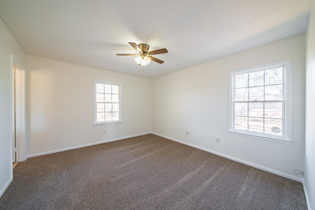 1829 Celeste Drive Columbus, GA 31907 - Photo 23 of 33 an empty room with windows and ceiling fan
