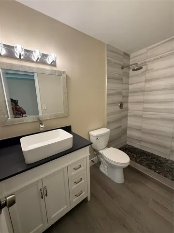 a bathroom with a toilet a sink and shower