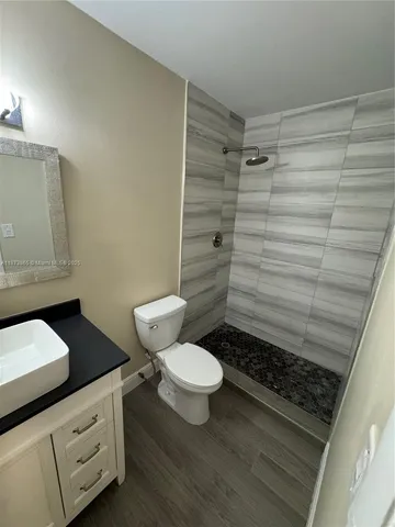 a bathroom with a toilet and a shower