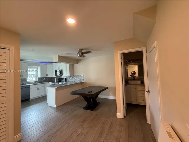 a kitchen with sink cabinets and wooden floor