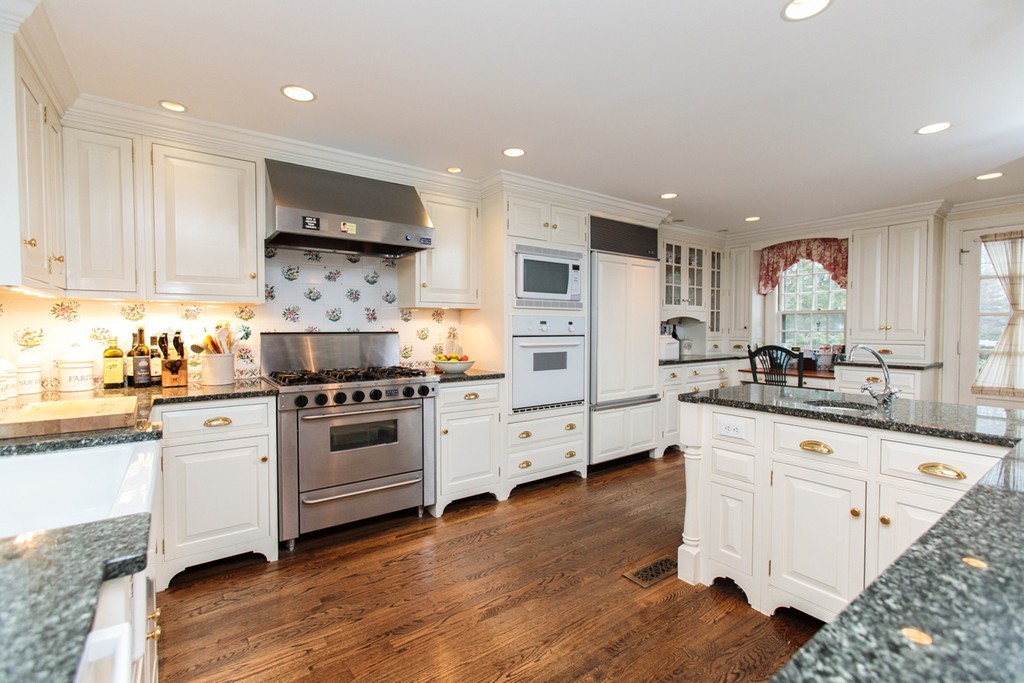 30 Old Farm Road Wellesley, MA 02481 - Photo 10 of 15 a kitchen with stainless steel appliances kitchen island granite countertop a sink cabinets and wooden floor