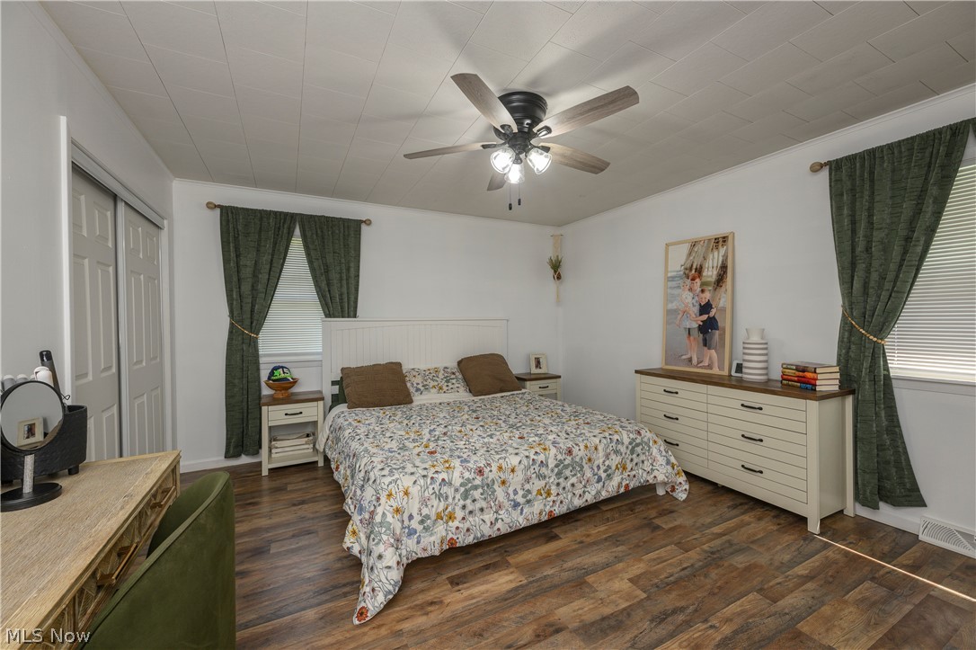 6105 Wolf Run Road Southeast Dennison, OH 44621 - Photo 29 of 35 Bedroom featuring wood-finish flooring, white walls, and a ceiling fan with integrated lighting