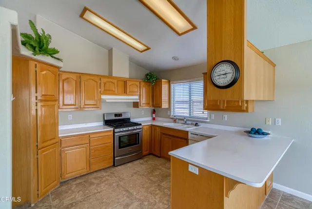 a kitchen with cabinets and stainless steel appliances