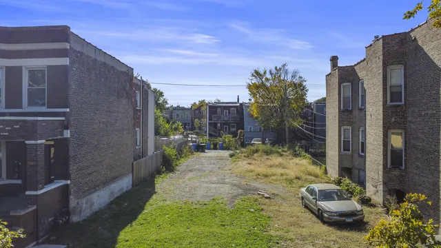 a view of a backyard with table and chairs