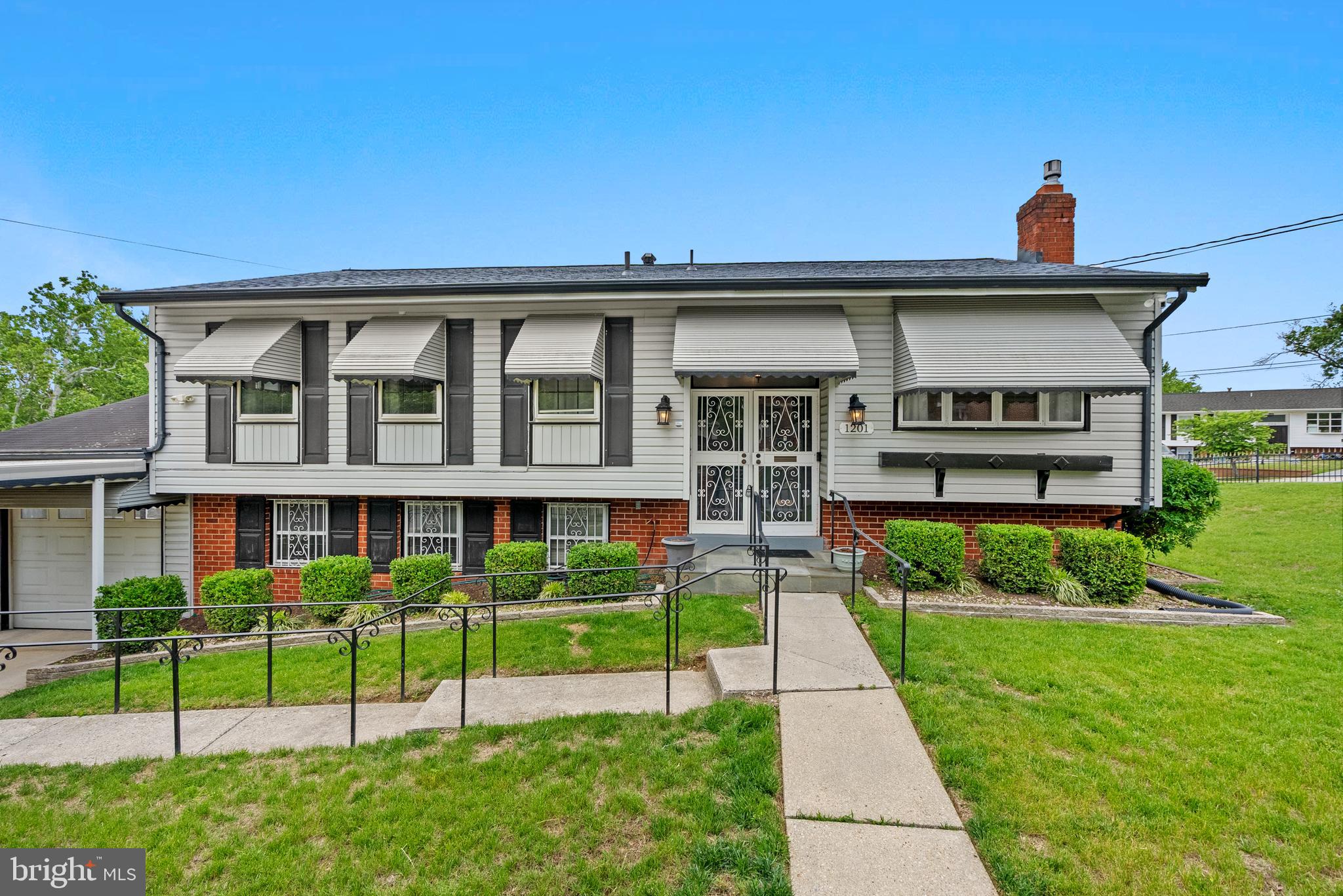 1201 Chillum Manor Road Hyattsville, MD 20783 - Photo 2 of 49 a front view of a house with a garden and plants
