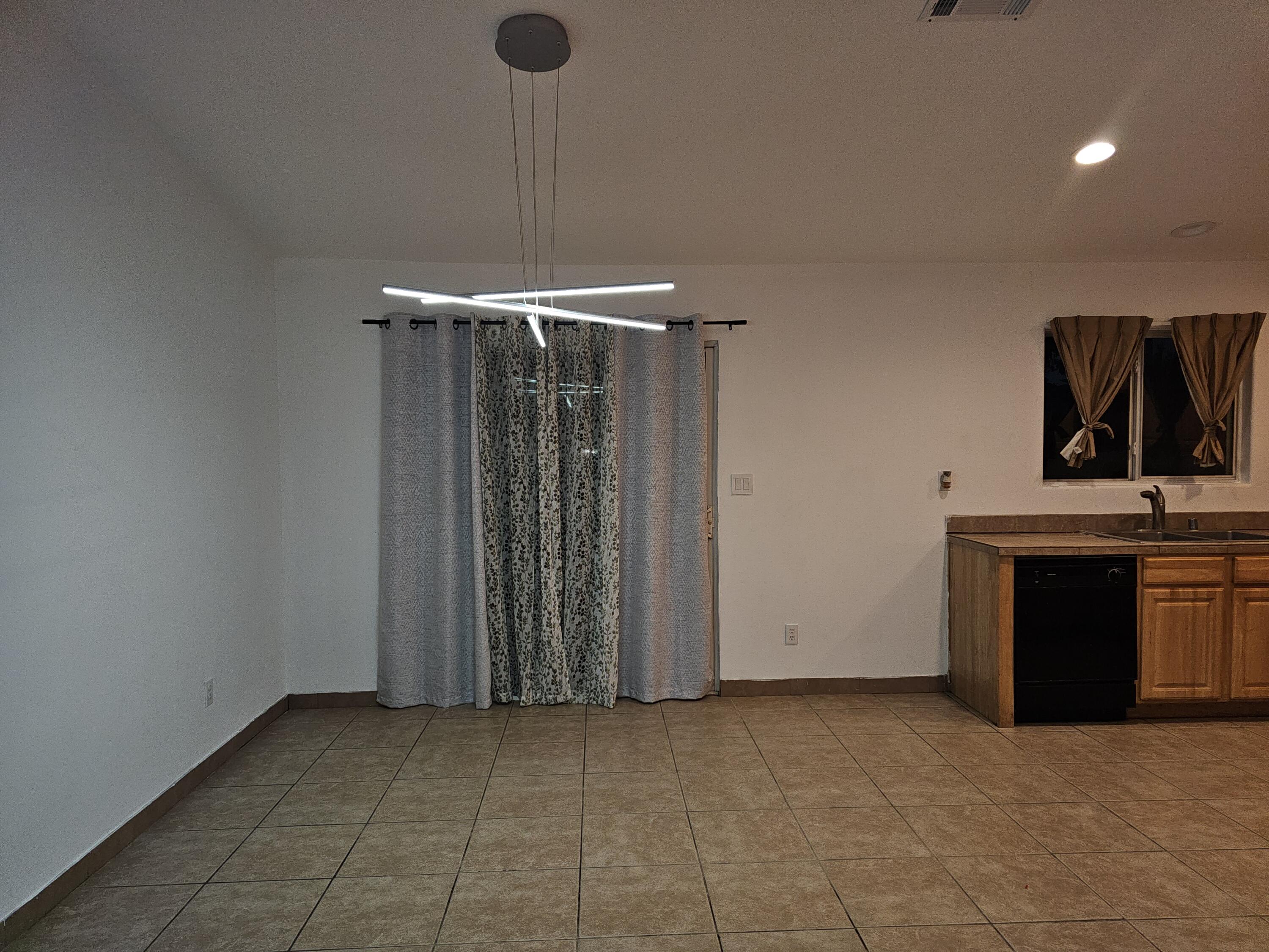 2799 Jester Avenue Thermal, CA 92274 - Photo 6 of 16 a view of an empty room with a fireplace and a window