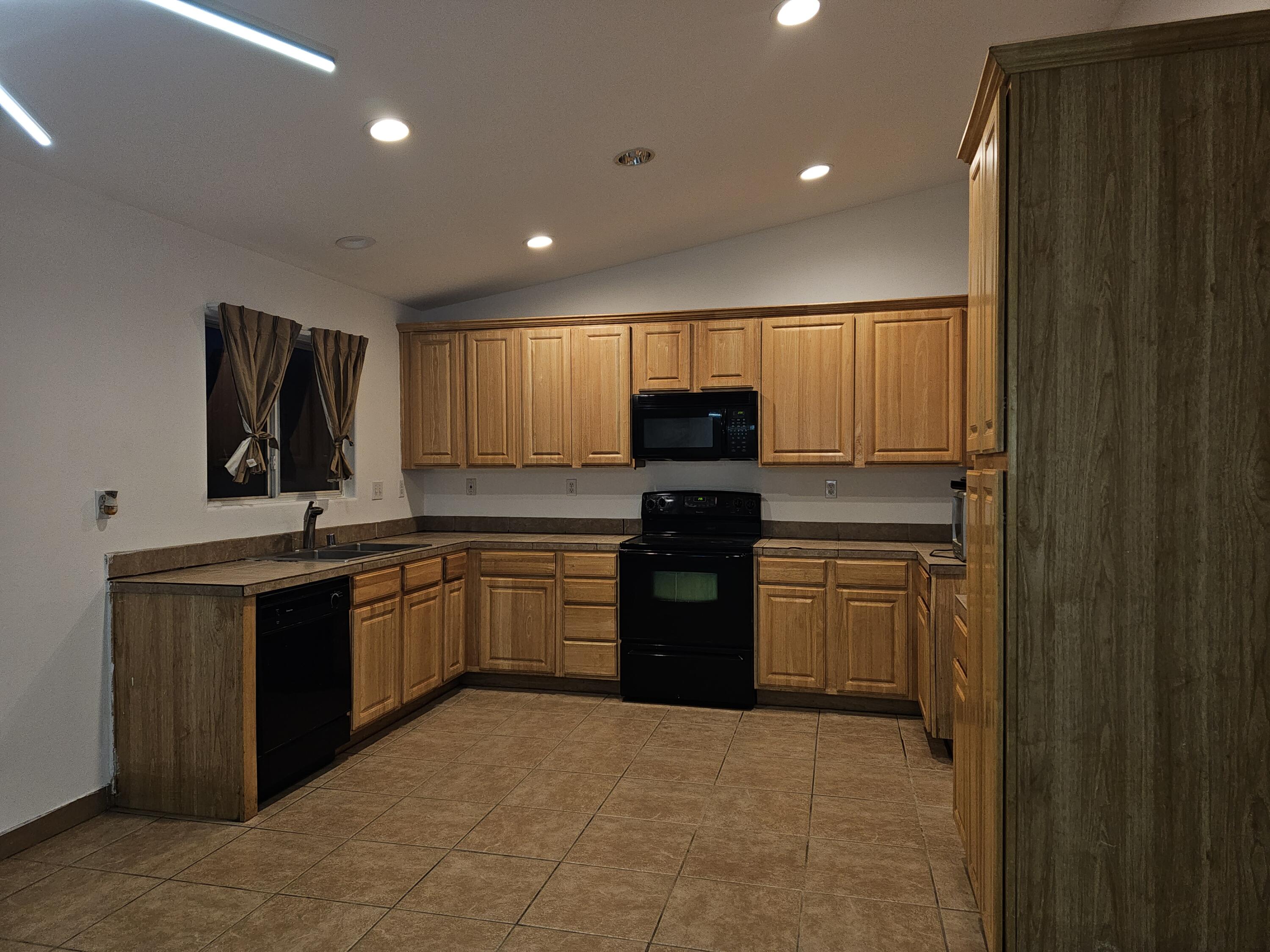 2799 Jester Avenue Thermal, CA 92274 - Photo 7 of 16 a kitchen with stainless steel appliances granite countertop a refrigerator sink and stove