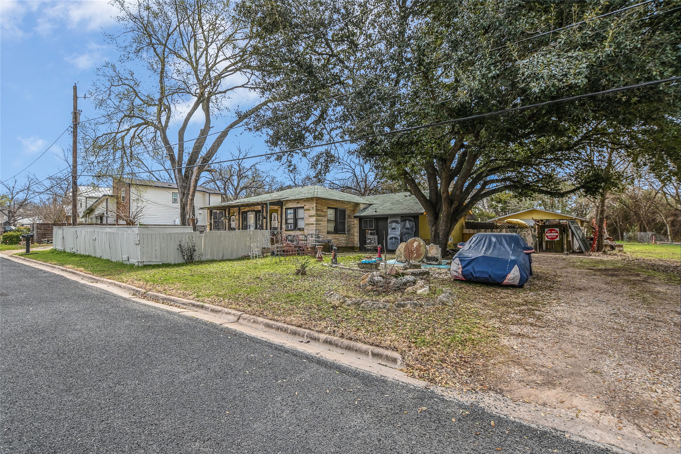 5405 Prock Lane Austin, TX 78721 - Photo 4 of 13 a front view of a house with a yard and garage