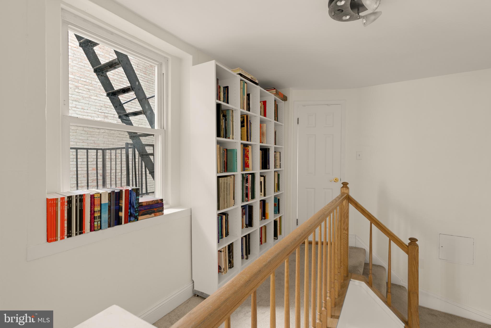 512 Cathedral Street, Unit 3 Baltimore, MD 21201 - Photo 17 of 38 a view of staircase with lots of frames on wall and a window