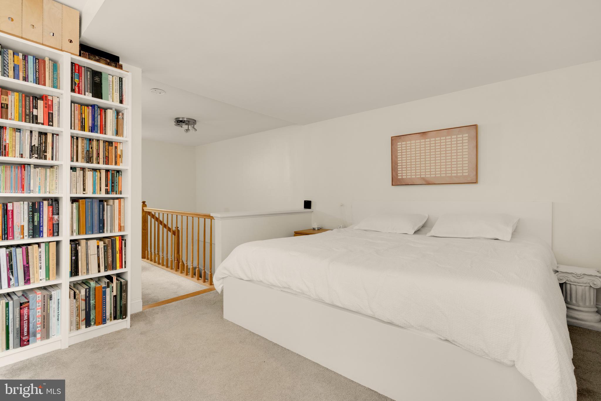 512 Cathedral Street, Unit 3 Baltimore, MD 21201 - Photo 19 of 38 a bedroom with a bed and a book shelf