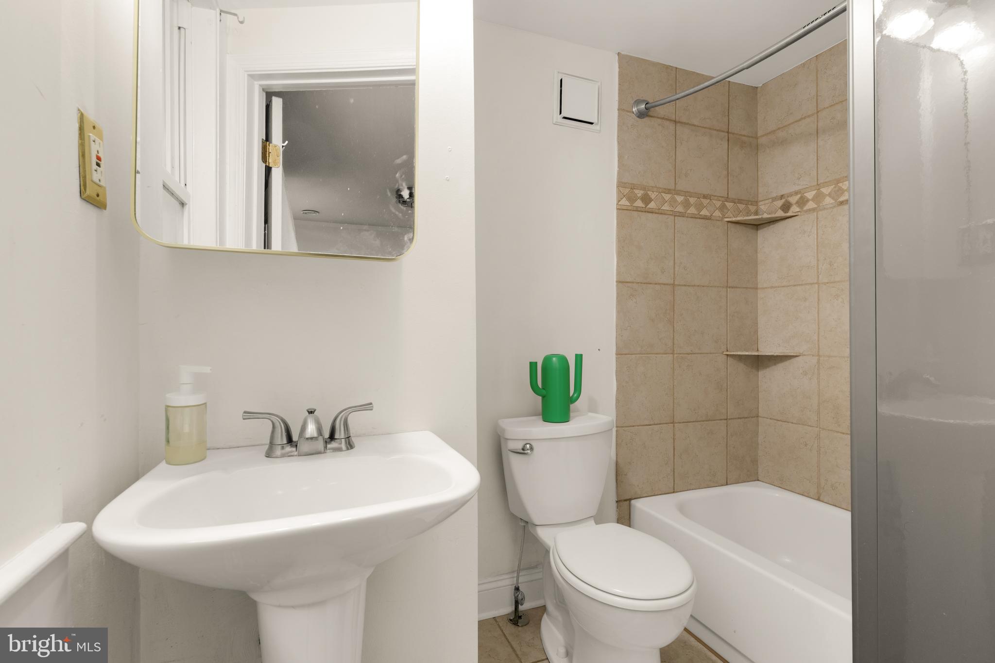 512 Cathedral Street, Unit 3 Baltimore, MD 21201 - Photo 27 of 38 a bathroom with a sink toilet and shower