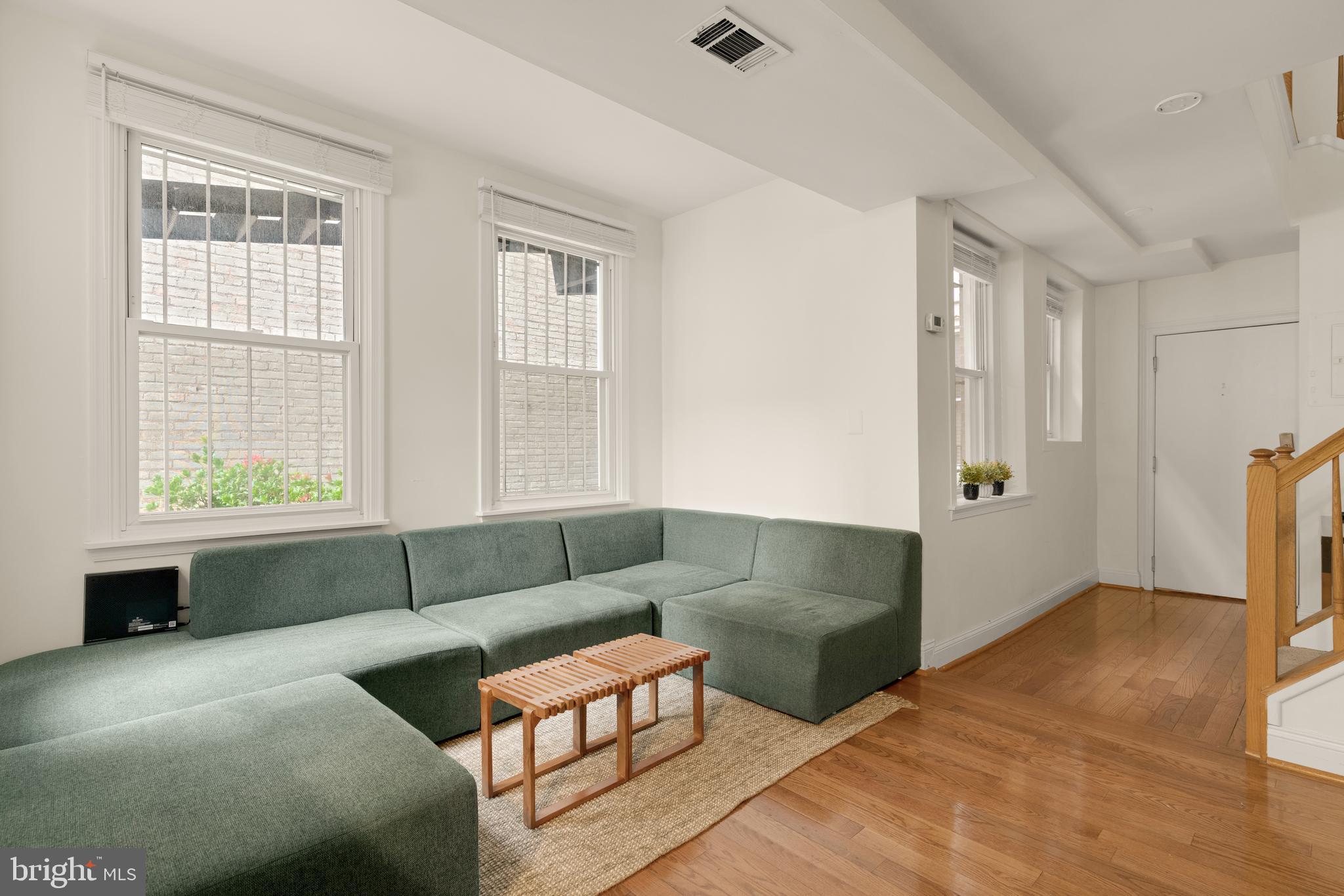 512 Cathedral Street, Unit 3 Baltimore, MD 21201 - Photo 7 of 38 a living room with furniture and a window
