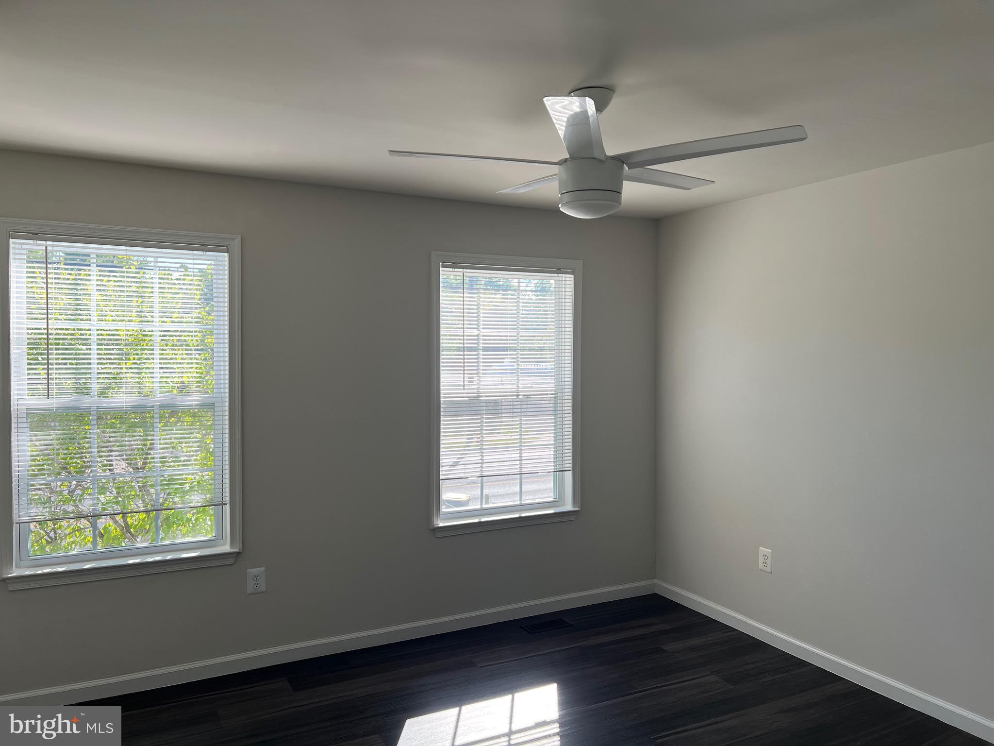 6604 Suitland Road Suitland, MD 20746 - Photo 22 of 27 an empty room with wooden floor windows and fan