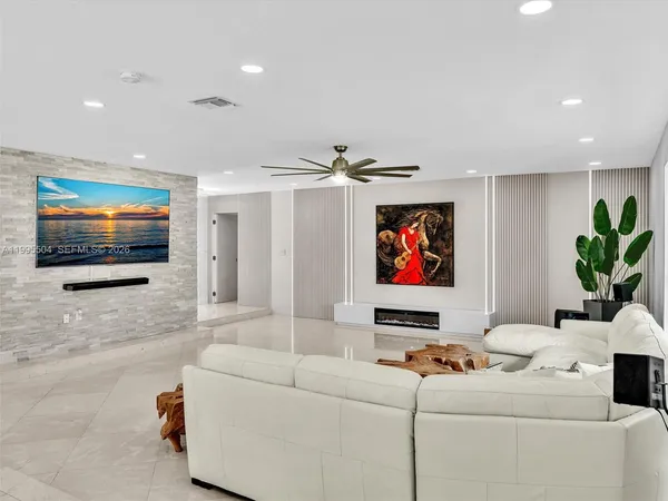a bedroom with furniture and a flat screen tv