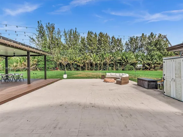 a kitchen with stainless steel appliances granite countertop a sink a microwave and wooden cabinets
