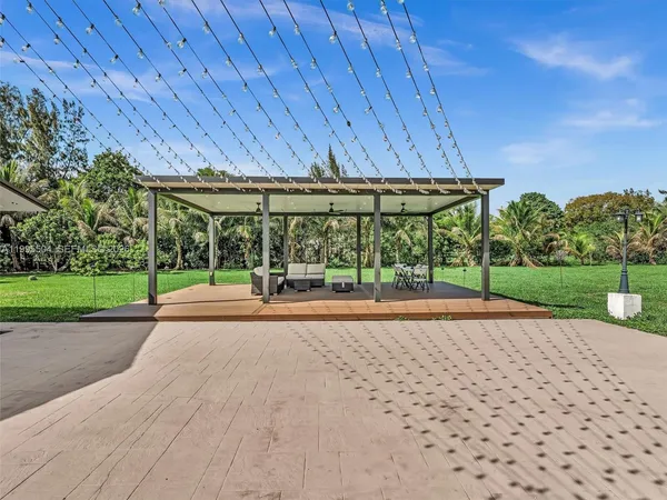 a large kitchen with stainless steel appliances a stove a sink dishwasher and cabinets with wooden floor