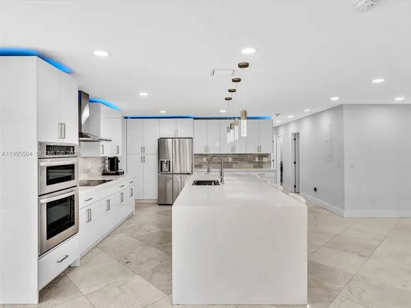 a living room with furniture and kitchen view