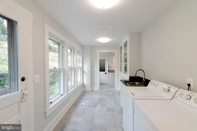 a view of a room with a window and refrigerator