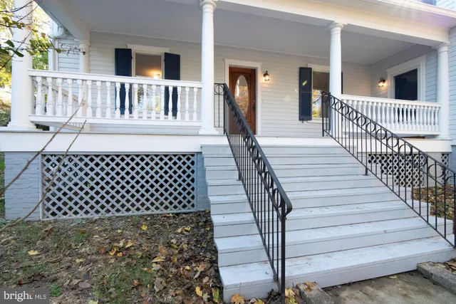 a view of a brick house with wooden fence