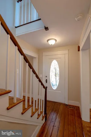 a view of wooden floor in a hallway