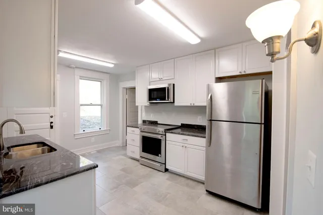 a kitchen with a refrigerator sink and stove
