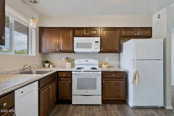 a kitchen with a sink a stove and refrigerator