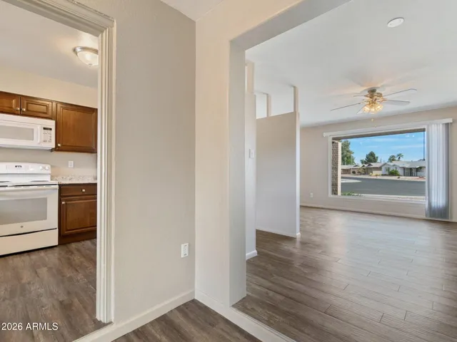 a view of a hallway with wooden floor and fireplace