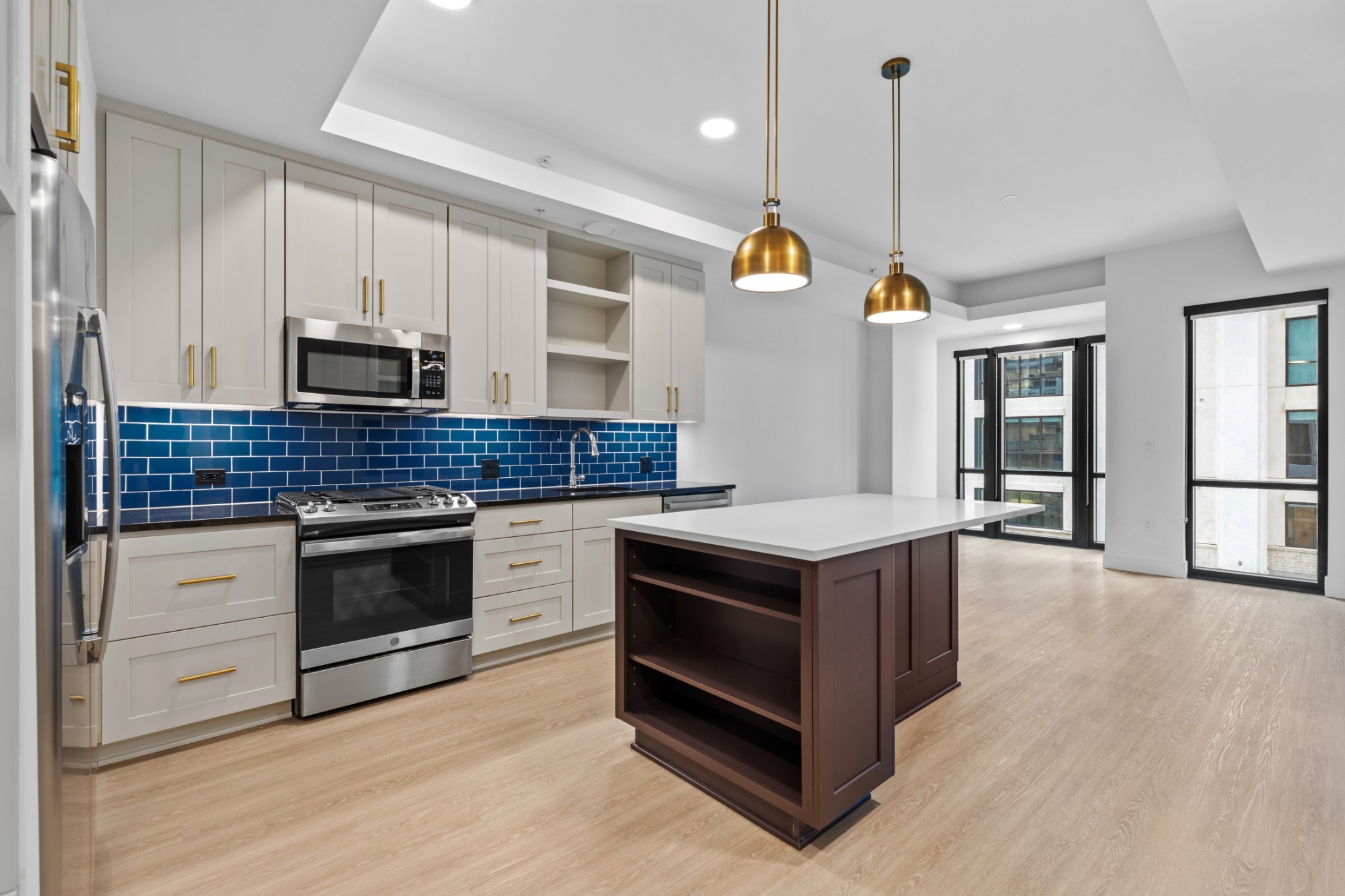 930 Commerce Street, Unit 508 Nashville, TN 37203 - Photo 6 of 65 a kitchen with stainless steel appliances granite countertop a stove a sink and a wooden floors